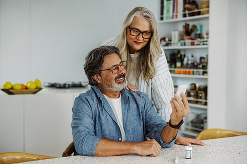 Senior couple monitor diabetes with a glucometer