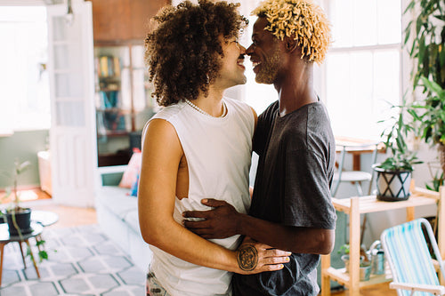 Romantic young gay couple embracing each other