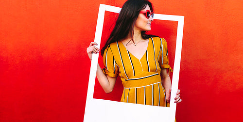 Pretty woman with a empty picture frame