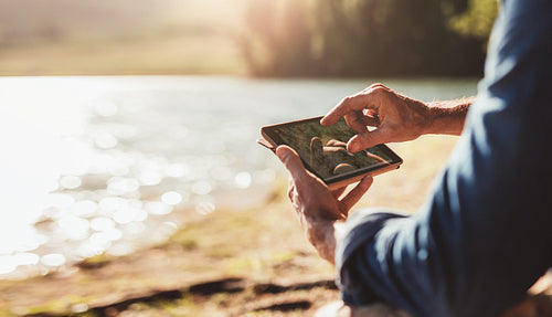Male hands using digital tablet for navigation