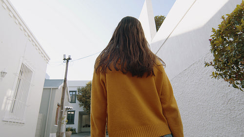 Beautiful woman walking down the street and dancing