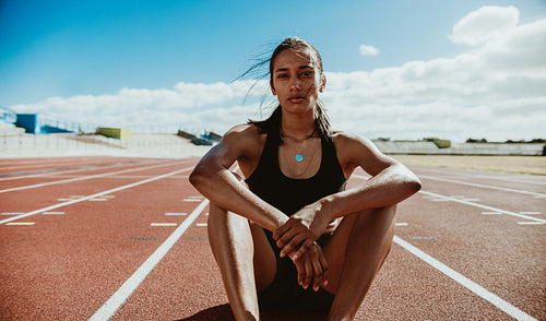 Professional athlete relaxing on the track after training session