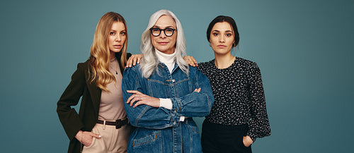 Trio of self-assured women standing together