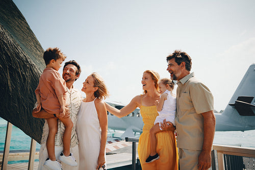 Happy family enjoying tropical holiday resort with seaplane background