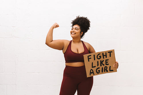 Healthy woman with "Fight like a girl" placard