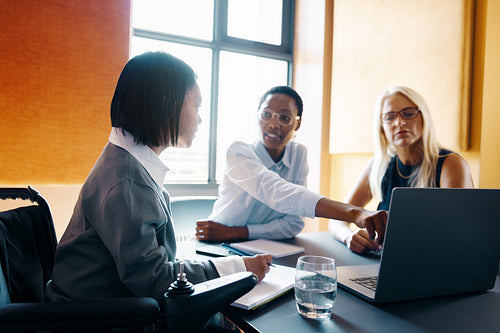 Three professionals discussing a project together in a modern office setting