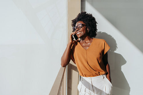 Professional woman talking on the phone on an office balcony