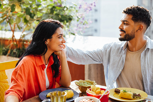 Happy couple enjoying a meal together at an outdoor setting