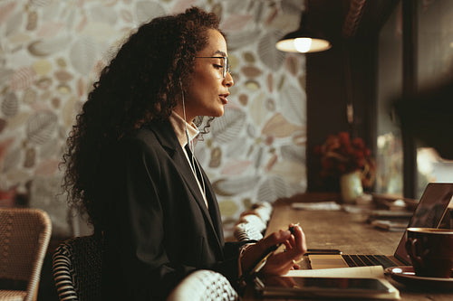 Businesswoman working from a cafe