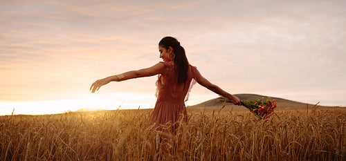 Happy woman enjoying in wheat field
