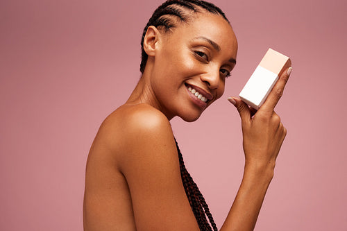 Woman showing skincare product