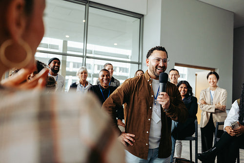 Facilitating collaboration: Team leader engaging with group in modern office meeting