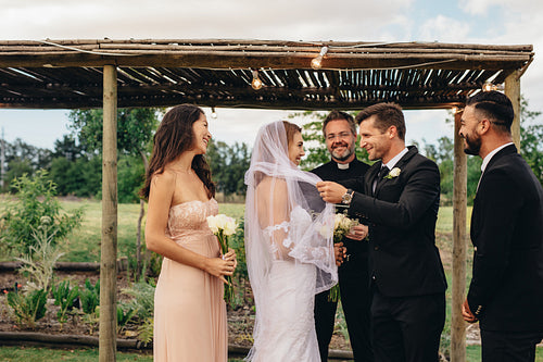 Newlywed couple about to kiss after the ceremony