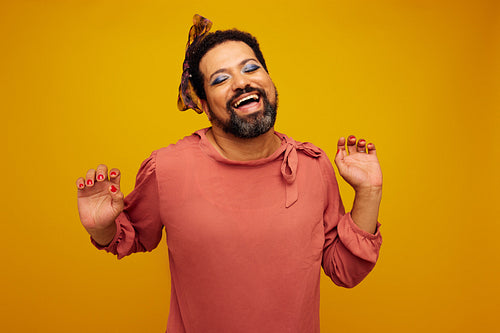 Nonconforming model in female outfit and makeup dancing