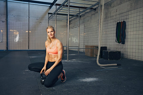 Sports woman at crossfit gym with kettlebell