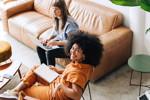 Happy young businesswoman smiling at the camera in an office