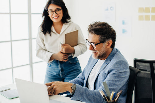 Business man discussing his progress on a design project with his workmate