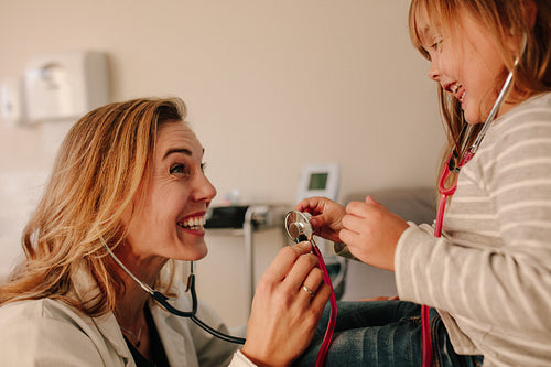 Pediatrician playing with her little patient