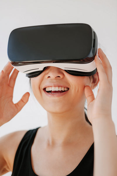 Smiling woman using the VR goggles