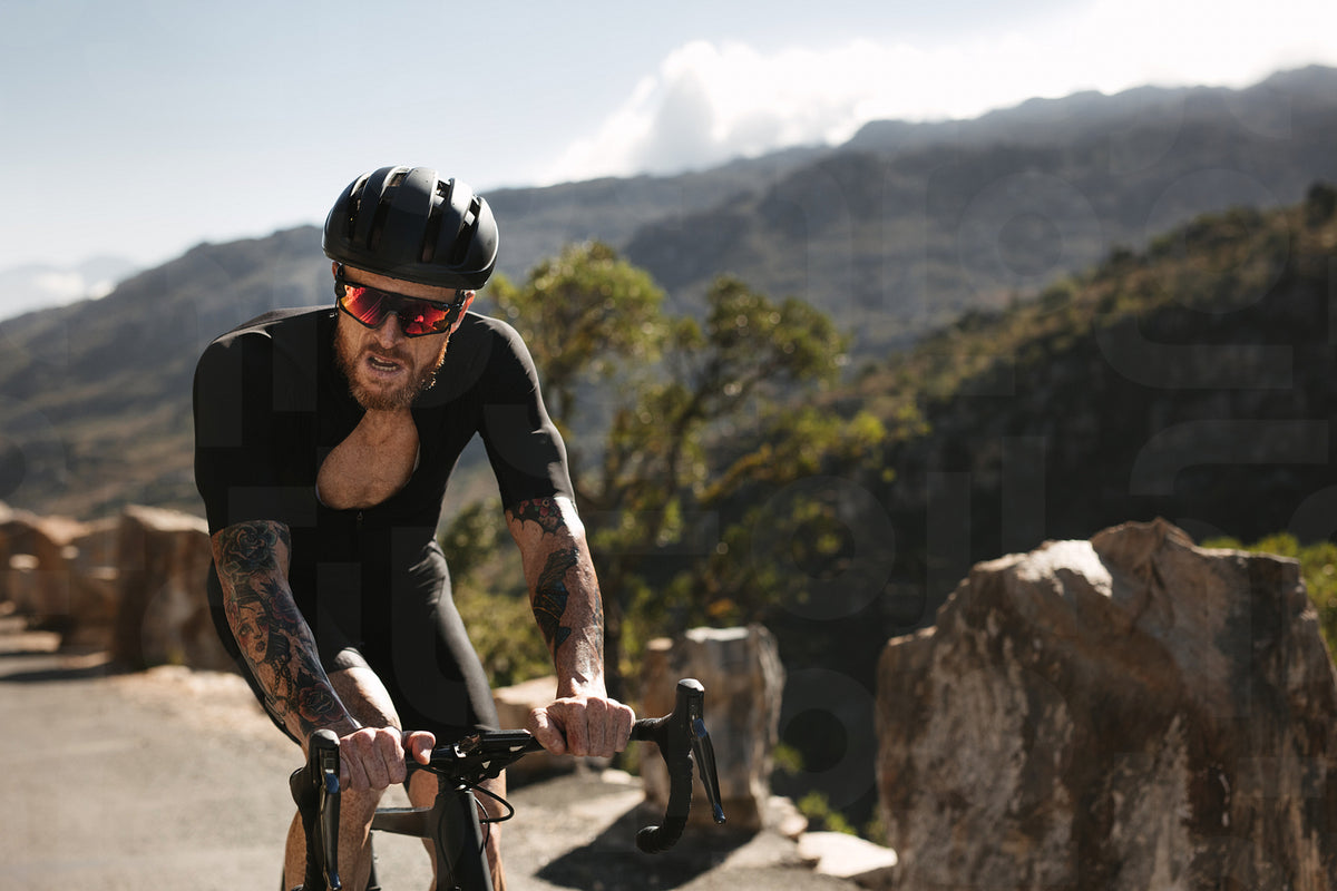 Racer riding a bicycle on mountain road – Jacob Lund Photography Store ...