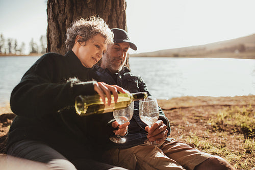 Senior couple enjoying outdoors camping near a lake