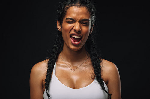 Woman in fitness wear winking eye