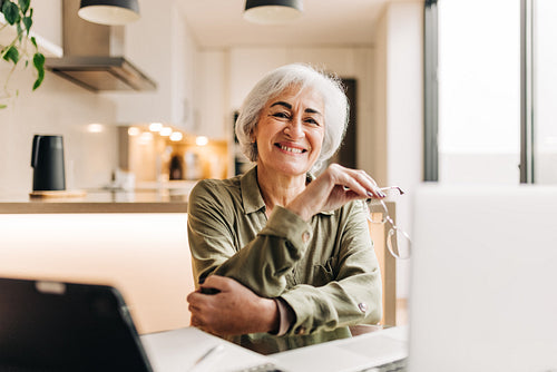 Successful senior businesswoman working in her home office