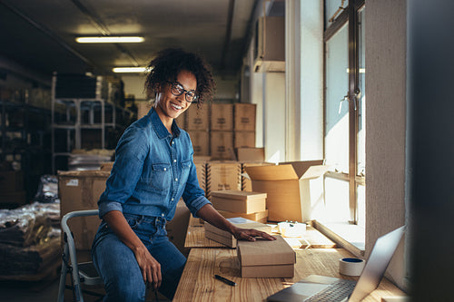 Woman packing the parcel for shipping