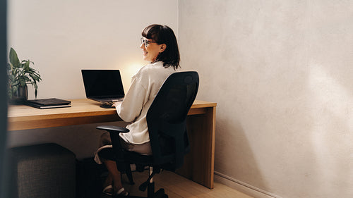 Creative businesswoman working in a contemporary office with natural lighting and decor