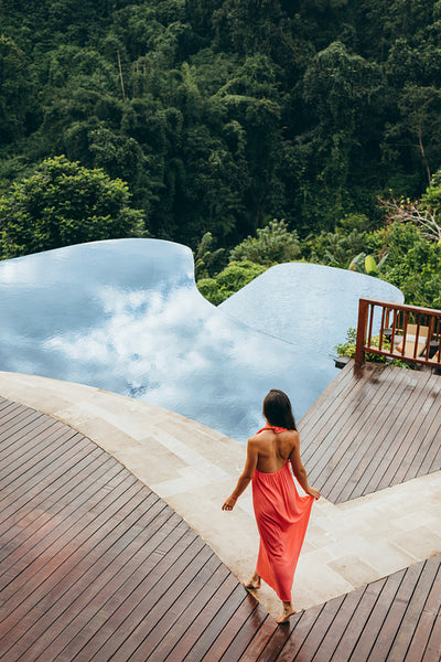 Young woman at luxury resort poolside