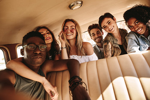 Group of friends taking selfie on road trip