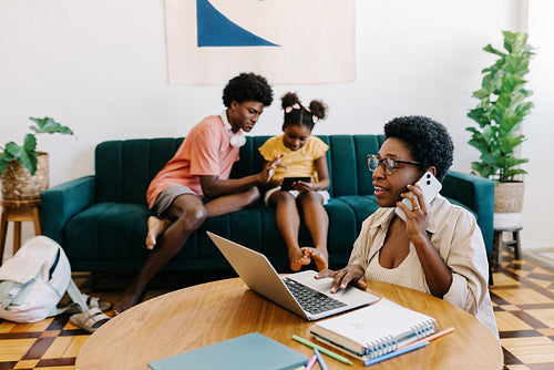 Mom working from home, with her kids in the background