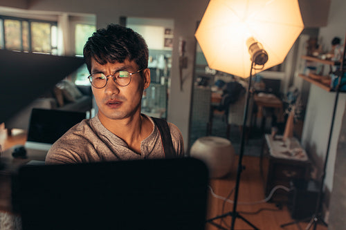 Photographer adjusts studio lights before the shoot