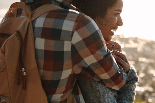 Smiling woman in arms of her boyfriend