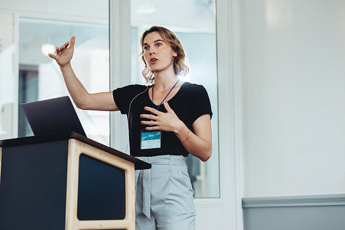 Businesswoman speaking from a podium