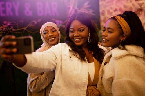 Girlfriends taking a selfie in a restaurant
