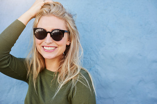 Pretty young woman in sunglasses smiling