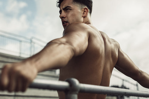 Sportsman relaxing at stadium stands after workout