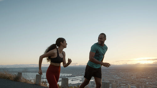 Couple running on the road in the mountains