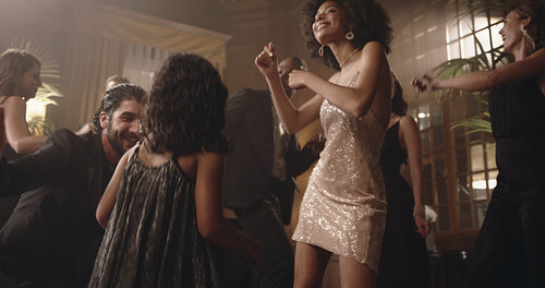 Mother and daughter having fun dancing at party