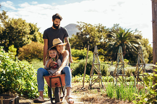 Father gives mother and daughter ride in wheelbarrow