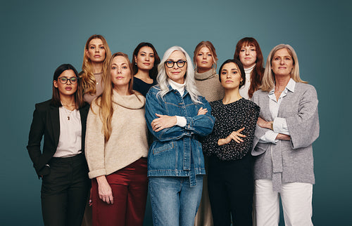 Strong women of different ages standing together in a studio
