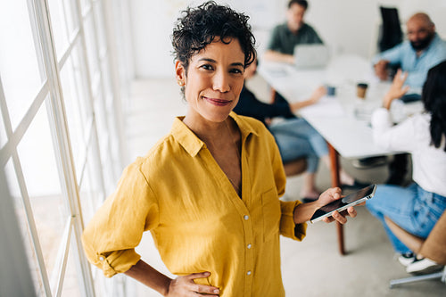 Professional woman using a cellphone in an office