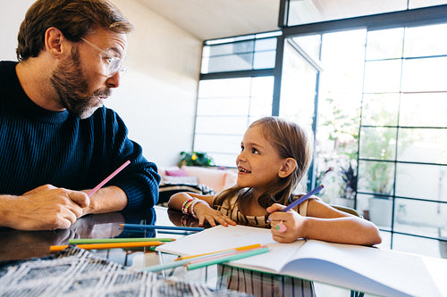 Father and daughter create art at home