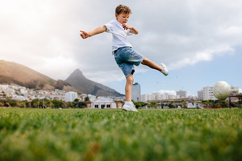 Boy playing football in a park