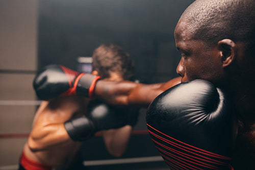 Young boxer missing a punch during a match