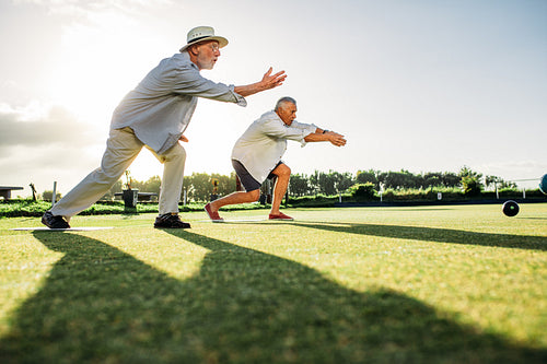 Old men playing a game of boules together