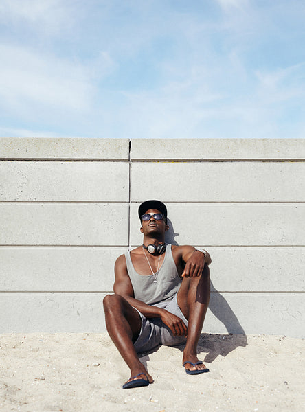 Young african man relaxing on the beach.