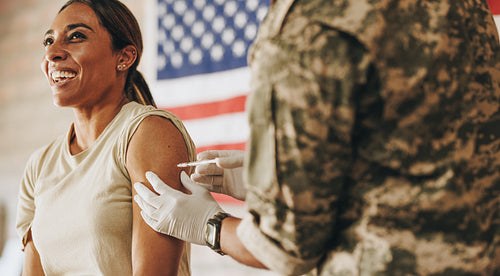Servicewoman receiving a vaccine in her arm