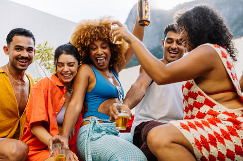 Group of friends dancing and celebrating at a rooftop party in Rio